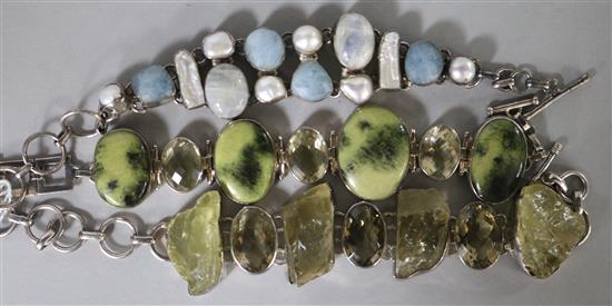 Three silver and gemstone set bracelets.